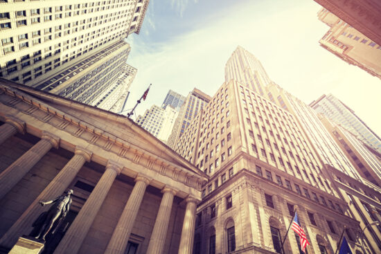 Vintage toned Wall Street at sunset, NYC.