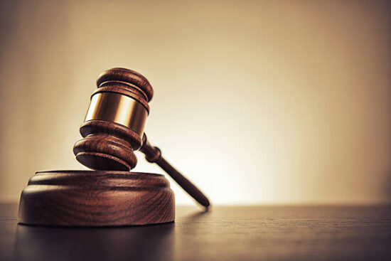 Gavel on desk. Isolated with good copy space. Dramatic lighting.